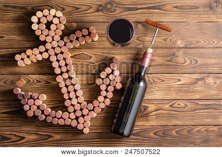 Wine Marine Theme With Unlabelled Bottle And Corkscrew, Glass Of Red Wine And Many Corks In The Shap