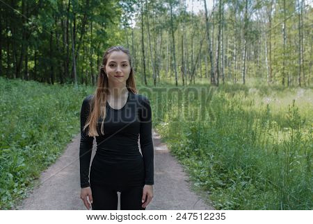 Young Sporty Girl Go To The Training With Equipment. Forest In The Summer. Red Hair.