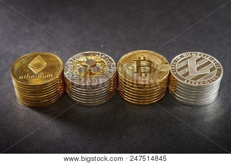 Stack Of Cryptocurrencies. Etherum, Ripple, Bitcoin. Litecoin On Dark Leather. Luxury Concept Of Cry