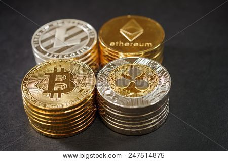 Stack Of Cryptocurrencies. Etherum, Ripple, Bitcoin. Litecoin On Dark Leather. Luxury Concept Of Cry
