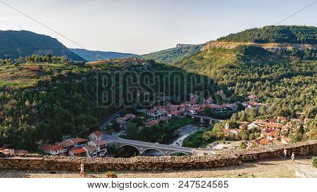 Panoramic View Of Veliko Tarnovo From Tsarevets Hill. Medieval Ruins Of Tsarevets Fortress And Typic