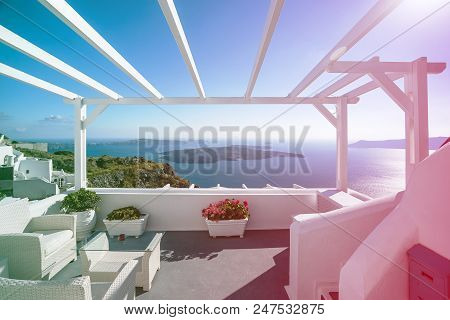Gourgeous Balcony View In White Walled Resort In Santorini, Greece, With Ocean And Cliffs In The Bac