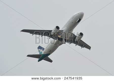 Passenger Airplane Flying In The Sky