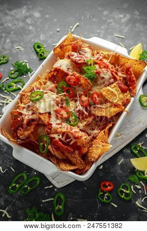 Maxican-style Tortilla Nachos Chips Topped With Tomato Salsa, Sliced Chilies And Melted Cheese Serve