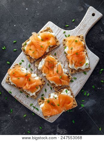 Homemade Crispbread Toast With Smoked Salmon And Soft Chees, Chives On White Board.