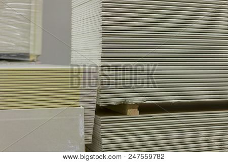 Pallet With Plasterboard In The Building Store. Warehouse With Plasterboard. Sheets Of Plasterboard 