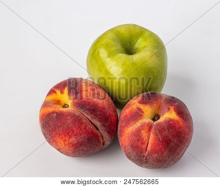 Green Apple And Two Peaches On White Background