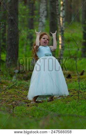 Little Emotional Girl Walks In A Summer Forest In A Dress