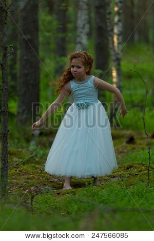 Little Emotional Girl Walks In A Summer Forest In A Dress