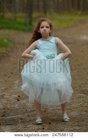 Little Emotional Girl Walks In A Summer Forest In A Dress