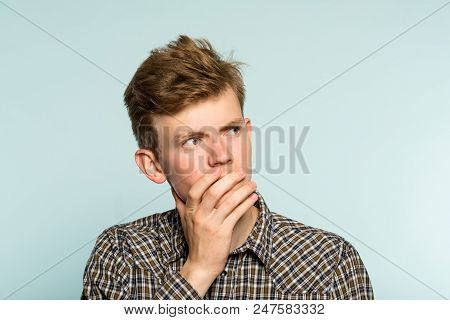 Puzzled Confused Bewildered Man Thinking Of Smth Looking Sideways. Portrait Of A Young Guy On Light 
