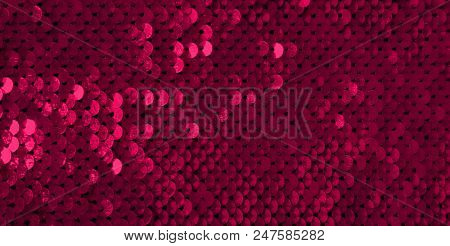 Glamor Red Background With Sequins Close-up. Abstract Texture Scales With Shiny Maroon Sequins On Fa