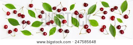 Cherry Background. Panoramic Composition Of Large Group Of Red Cherry Berries And Green Leaves On Wh