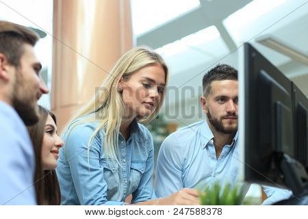 Group Of Young Modern People In Smart Casual Wear Having A Brainstorm Meeting While Standing In The 