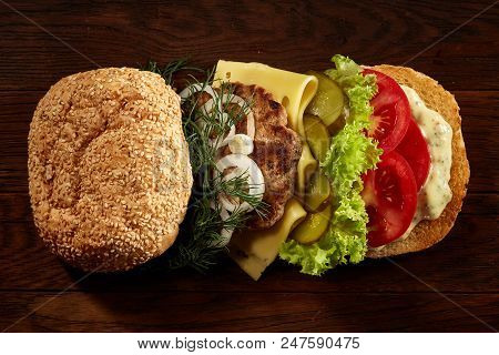 Close-up Of Delicious Fresh Home Made Burger With Piccoli, Lettuce, Cheese, Onion, Tomato, Dill And 