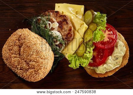 Close-up Of Delicious Fresh Home Made Burger With Piccoli, Lettuce, Cheese, Onion, Tomato, Dill And 