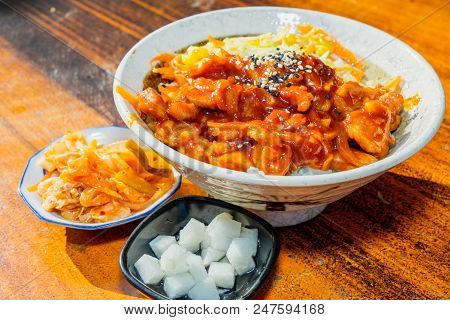 Korean Stir Fried Chicken Rice In White Bowl On Wooden Able