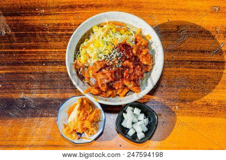 Korean Stir Fried Chicken Rice In White Bowl On Wooden Able