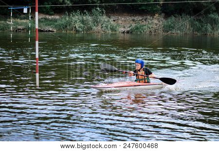 Young Teenager Girl Actively Manages A Sports Kayak Boat On A Beautiful River