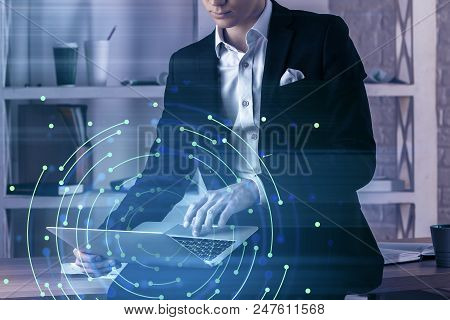 Businessman In Suit With Laptop Sitting On Deskin Office And Digital Interface Illustration. 3d Rend