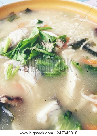Homemade Rice Soup With Vegetables And King Fish In White Bowl. Thai Style Food.