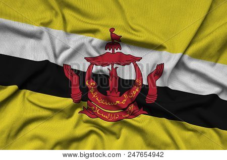 Brunei Darussalam Flag  Is Depicted On A Sports Cloth Fabric With Many Folds. Sport Team Waving Bann