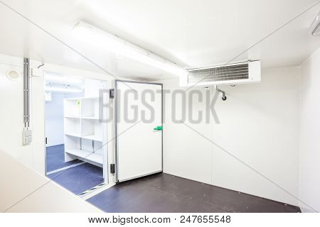 An Empty Industrial Room Refrigerator With Four Fans