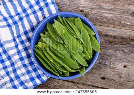 Blue Bowl With Green Peapods And Towel