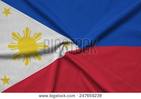 Philippines Flag  Is Depicted On A Sports Cloth Fabric With Many Folds. Sport Team Waving Banner