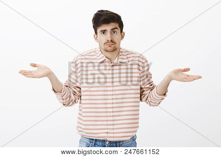 No Clue, No Guesses. Portrait Of Gloomy Unsure Boyfriend With Moustache, Shrugging With Spread Palms