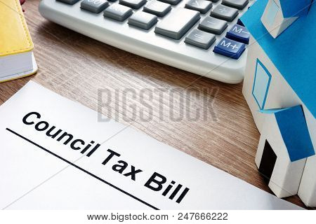 Council Tax Bill And Model Of House On A Desk.