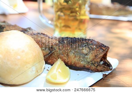 Fresh Mackerel On Stick At Barbecue Party. Germany