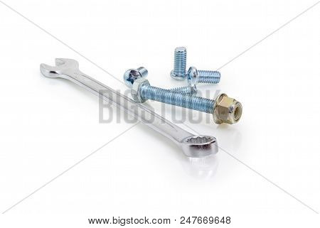 Chrome-plated Combination Wrench Open At One End And Ring At The Other Among Of Screws And Bolt With