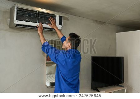 Serivce Manager Repairing Air Conditioner In Apartment