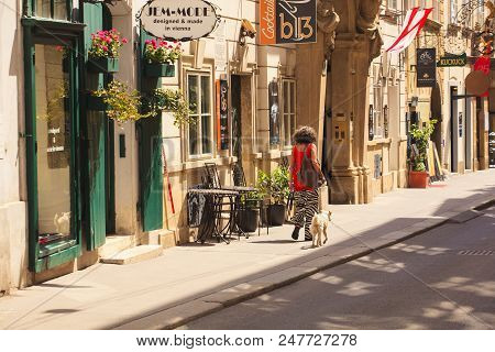 Vienna, Austria - May, 22: Woman Walking With Her Dog In The Vienna Street On May 22, 2018