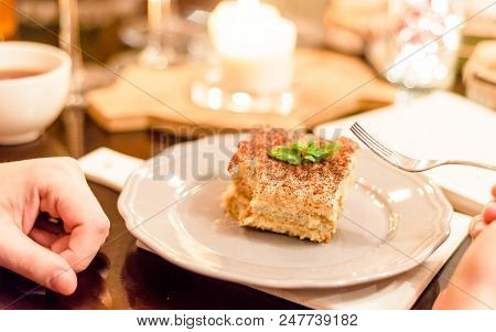 Tiramisu By Candlelight, Romantic Date In Italy, Tiramisu Dessert On A Porcelain Plate