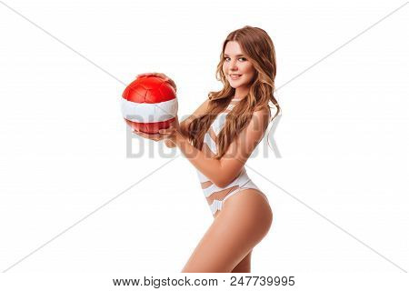 Pretty Bikini Model Holding Red Ball In Studio On Red Background