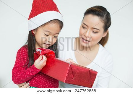 Attractive Asian Girl Received A Present At Brithday With Her Family. Kid Holding Gift With Attracti