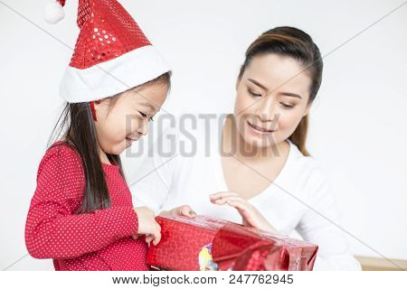 Attractive Asian Girl Received A Present At Brithday With Her Family. Kid Holding Gift With Attracti