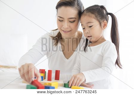 Mam Playing Toy With Her Daugther At Home. Happy Family Concept.