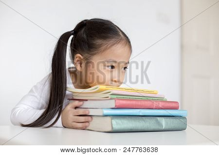 Attractive Little Girl Holding Book With Smiling. Happy Children Lifestyle, Education Concept.