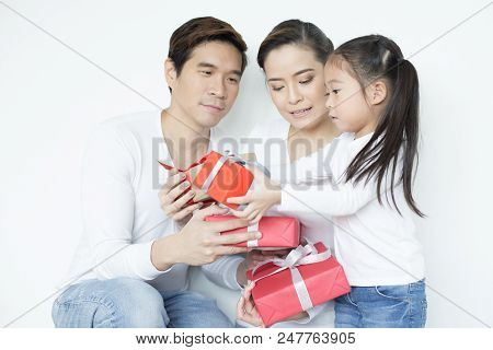 Attractive Asian Family Holding With Each Other. Kid Received Gift With Attractive Smiling. Kid With