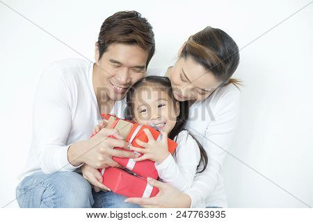 Attractive Asian Family Holding With Each Other. Kid Received Gift With Attractive Smiling. Kid With