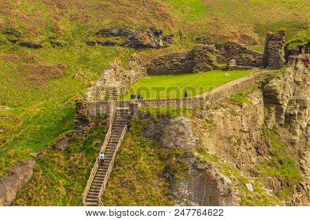 Tintagel, United Kingdom - May 02, 2014: View Of Tintagel Island And Legendary Tintagel Castle Ruins