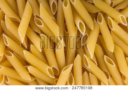 Background Of Pasta Penne. The Small Tube Shape Is Great With Many Different Sauces And Baked Dishes