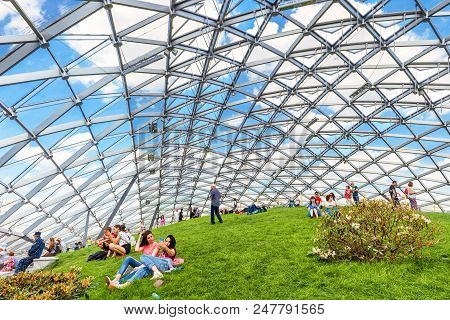 Moscow - June 17, 2018: People Relax In A Modern Amphitheater With Glass Dome In Zaryadye Park Near 