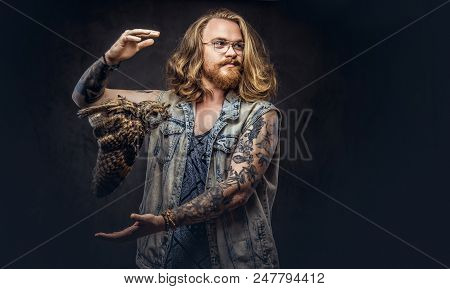 Portrait Of A Tattoed Redhead Hipster Male With Long Luxuriant Hair And Full Beard Dressed In A T-sh