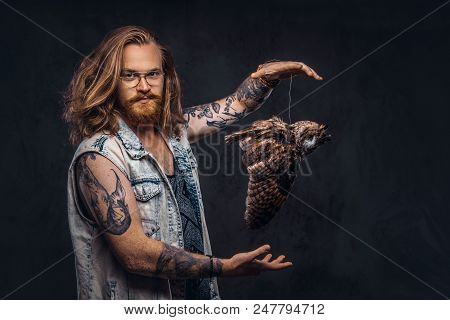 Portrait Of A Tattoed Redhead Hipster Male With Long Luxuriant Hair And Full Beard Dressed In A T-sh