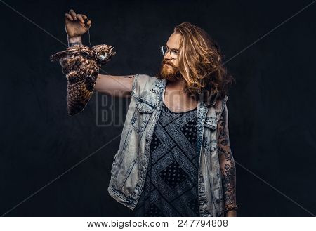Portrait Of A Tattoed Redhead Hipster Male With Long Luxuriant Hair And Full Beard Dressed In A T-sh