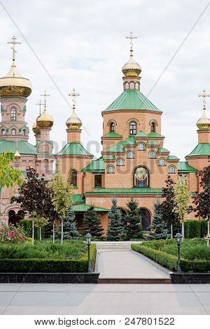 The Big Christian Church With Domes And The Green Yard